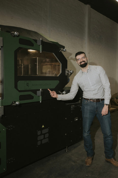 Arrowroot’s electric coffee roaster with a member of the team